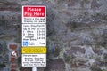 Please pay parking fee here car parking sign for ticket information Royalty Free Stock Photo