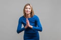 Please! Portrait of upset woman holding hands in prayer and pleading. isolated on gray background