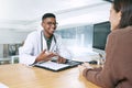 Please remember these two things. a handsome doctor sitting with his patient and explaining her diagnosis during a Royalty Free Stock Photo