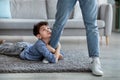 Please stay, dad. Sad little boy embracing his father leg and looking up Royalty Free Stock Photo