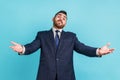 Please, take for free. Bearded businessman in official style suit outstretching hands as if sharing Royalty Free Stock Photo
