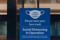 Please wear your face mask sign at the entrance of an office building in London, UK Royalty Free Stock Photo