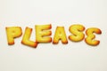 please word from alphabet biscuits on white background Royalty Free Stock Photo