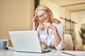 Pleased attractive mature businesswoman smiling at webcam, having online video call using laptop while sitting at her Royalty Free Stock Photo