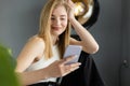 pleased blonde woman in white tank