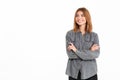 Pleased brunette woman in shirt with crossed arms looking aside