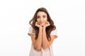 Pleased brunette woman in t-shirt reclines on her hands Royalty Free Stock Photo