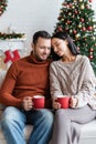 pleased couple with cups of warm