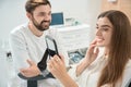 Pleased dental clinic client admiring her anterior teeth after whitening Royalty Free Stock Photo