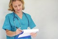 Pleased doctor checks report. Female doctor checking medical report Royalty Free Stock Photo