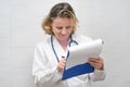 Pleased doctor checks report. Female doctor checking medical report Royalty Free Stock Photo