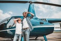 Pleased father and son standing near helicopter Royalty Free Stock Photo