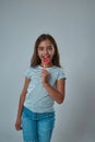 Pleased girl lick lollipop and look at camera Royalty Free Stock Photo