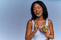 Dreamy woman with closed eyes with a fork eats cucumber from salad from a transparent plate. Diet concept