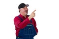 Pleased happy man in denim dungarees pointing up