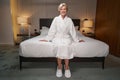 Pleased lady dressed in bath robe resting at hotel room Royalty Free Stock Photo