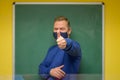 Pleased teacher signalling success with thumb up