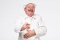 Pleased mature hispanic cook chef laughing pointing at you.