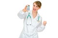 Pleased medical female doctor holding calculator