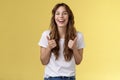 Pleased outgoing cheerful good-looking caucasian girl curly long haircut white t-shirt show thumbs up smiling lively