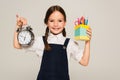 pleased schoolkid showing pen holder and