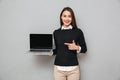 Pleased woman in business clothes showing blank laptop computer screen Royalty Free Stock Photo