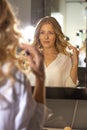 Pleased woman client looking to her reflection in the mirror Royalty Free Stock Photo