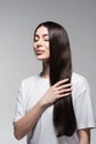 pleased woman touching smooth long hair