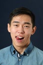 Pleased young Asian man showing his tongue Royalty Free Stock Photo