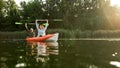 Pleased young couple looking happy, raised their hands with paddles in it while boating together in river on a summer Royalty Free Stock Photo