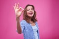 Pleased young girl with ok sign gesture