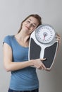 Pleased young lady hugging her scales with joy Royalty Free Stock Photo