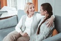 Positive delighted woman spending time with her granddaughter