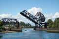 Pleasure boat below raised drawbridge