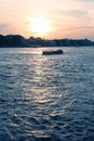 Pleasure boat floats on the river at sunset Royalty Free Stock Photo