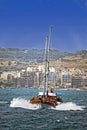 A pleasure boat with lots of sightseers aboard heading back to the shore .