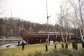 Pleasure boat moored to a pier, people walking around. Residence of former President Victor Yanukovich