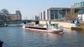 Pleasure boat with people on the Spree in Berlin against the background of the Bundestag and the Reichstag