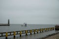 Pleasure boat sails into the harbor in the Baltic Sea. Royalty Free Stock Photo