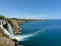 Pleasure boat in the sea near the shore with a waterfall Royalty Free Stock Photo