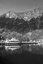 Pleasure boat at sea pier on mountain landscape in Flam, Norway. Small ship in sea harbor with green mountains