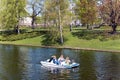 Pleasure boat with tourists cruise along the Riga river canal near Bastion park in Riga Royalty Free Stock Photo