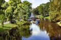 Pleasure boats cruise along the Riga river canal in Riga central city park Royalty Free Stock Photo