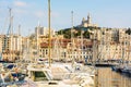 Pleasure boats moored in the Old Port of Marseille, France, and Notre-Dame de la Garde basilica at sunset Royalty Free Stock Photo