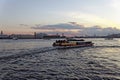 Pleasure boats on the Neva river in Saint Petersburg, Russia. Cityscape view in sunset