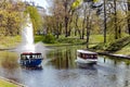 Pleasure boats with tourists cruise along the Riga river canal near Bastion park