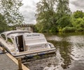 Holiday boat moored on the River Bure in the village of Hoveton and Wroxham, Norfolk, UK