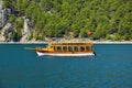 Pleasure motor yacht in the Green canyon against a continuous array of trees. Royalty Free Stock Photo