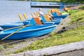 Pleasure paddle boat and catamarans on the shore near the water