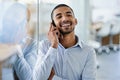 Always a pleasure taking your call. a handsome young businessman talking on his cellphone in the office. Royalty Free Stock Photo